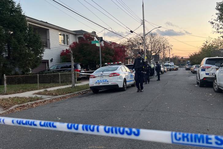 NYPD cordons off a section of the area by 146th Drive and 182nd Street in Springfield Gardens, Queens, the site of a triple homicide.